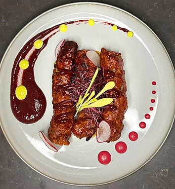 Nawabi seekh kebabs plated with sauces